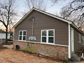 Jonesboro apartment for rent - A small house with a brown siding and a white door.