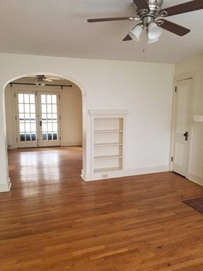 Pittsburgh apartment for rent - an empty living room with a wooden floor and a ceiling fan