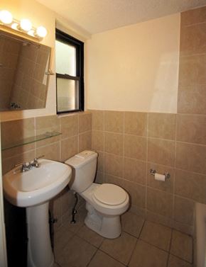 Pittsburgh apartment for rent - a bathroom with a toilet sink and a mirror