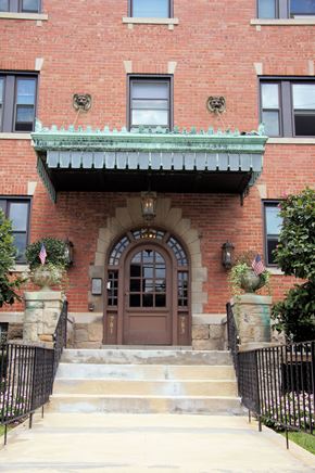 Pittsburgh apartment for rent - the front of a brick building with a brown door and stairs