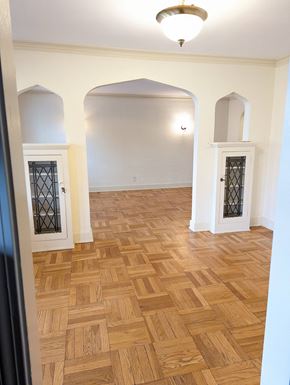 Pittsburgh apartment for rent - an empty living room with a wooden floor and a door