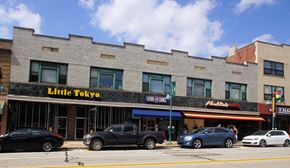 Pittsburgh apartment for rent - a brick building with a little restaurant on the side of a street