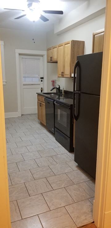 Pittsburgh apartment for rent - a kitchen with a black refrigerator and a black stove