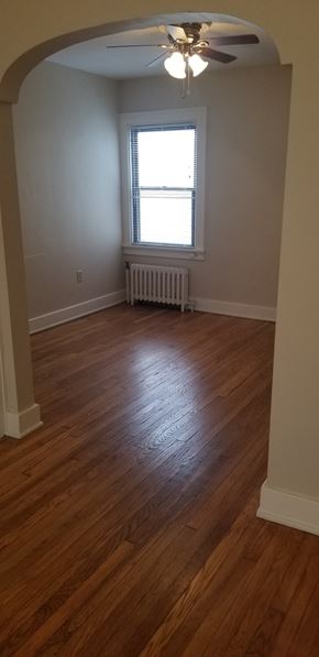 Pittsburgh apartment for rent - an empty living room with wooden floors and a window