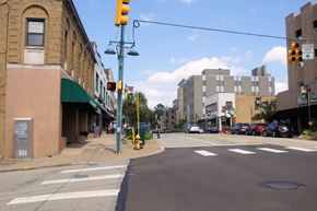 Pittsburgh apartment for rent - a city street with a yellow traffic light and a building on the corner