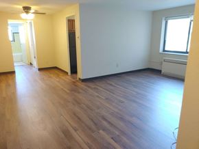 Pittsburgh apartment for rent - an empty living room with wooden floors and a window