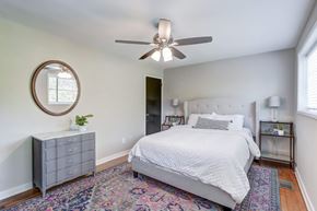 Richmond apartment for rent - A bedroom with a white bed and a grey dresser.