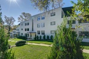 Richmond apartment for rent - A white building with a green lawn in front.