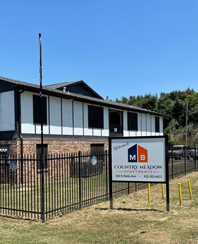 Hubbard apartment for rent - A sign for Country Meadow Apartments is displayed in front of a brick building.