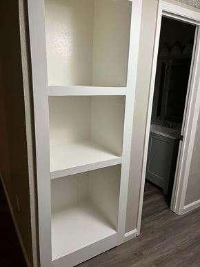 Hubbard apartment for rent - A white shelving unit with four shelves is open to the right.