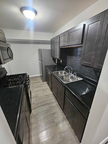 St. Louis house for rent - A kitchen with black cabinets and a black counter top.