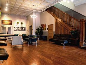 Kansas City apartment for rent - a living room with a wooden floor and a staircase