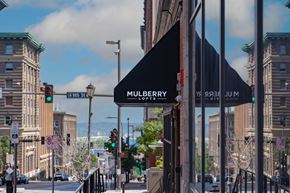 Kansas City apartment for rent - a store front with a black awning on a city street