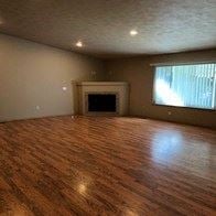 Spokane Valley apartment for rent - an empty living room with wooden floors and a fireplace