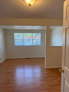 Trevose apartment for rent - A room with wooden floors and a window showing a view of a street.