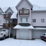 Spokane apartment for rent - A white car is parked in front of a garage.