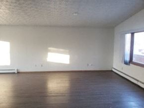 Eagle River apartment for rent - A room with a window and a wooden floor.