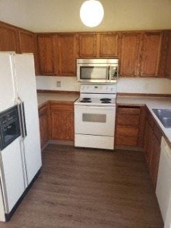 Eagle River apartment for rent - A kitchen with a white refrigerator and a white stove.