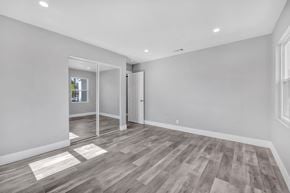 Granada Hills apartment for rent - the living room of a new home with white walls and wood floors
