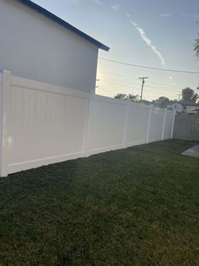 Granada Hills apartment for rent - a white fence in a backyard with green grass