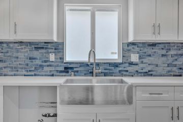 Granada Hills apartment for rent - a white kitchen with white cabinets and a stainless steel sink