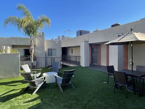 Los Angeles apartment for rent - a patio with a table and chairs and a palm tree