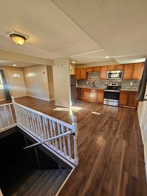 St. Louis house for rent - A kitchen with wooden floors and a staircase.