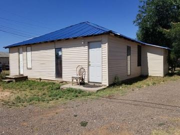 Levelland house for rent - a small white building with a blue roof