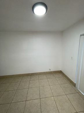 Lake Worth apartment for rent - A room with a white wall and a tiled floor.