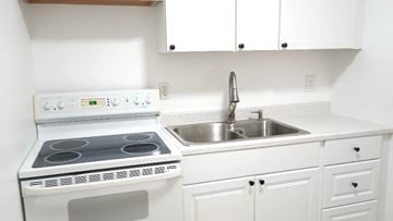 West Palm Beach apartment for rent - A white kitchen with a stove and sink.
