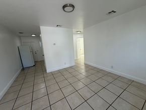 West Palm Beach apartment for rent - A spacious room with tiled flooring and white walls.