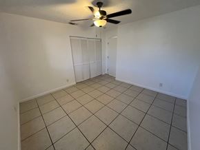 West Palm Beach apartment for rent - A room with a ceiling fan and tiled floor.