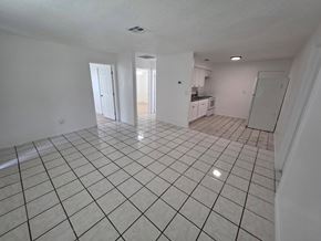 Fort Myers apartment for rent - A spacious room with white tile flooring and white walls.