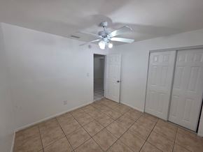 Fort Myers apartment for rent - A room with a ceiling fan and tile flooring.