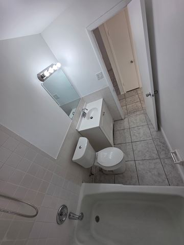 Fort Myers apartment for rent - A white bathroom with a toilet, sink, and shower.