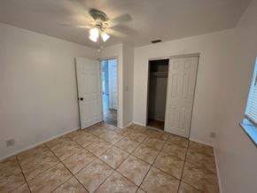 Fort Myers apartment for rent - A room with a ceiling fan and tile flooring.