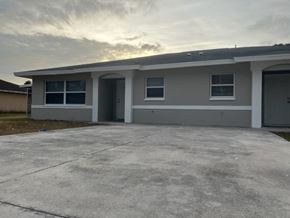 Lehigh Acres apartment for rent - A house with a grey roof and a grey garage door.