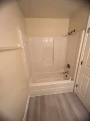 Lehigh Acres apartment for rent - A white bathroom with a bathtub and a toilet.