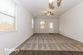 Cleveland house for rent - an empty living room with a ceiling fan and a window