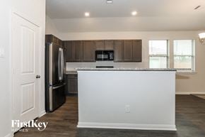 Cleveland house for rent - a kitchen with a counter top and a refrigerator