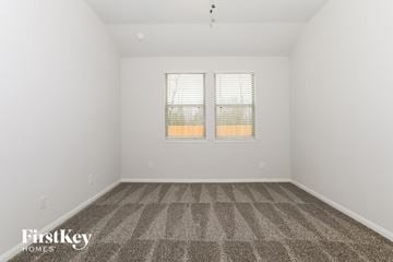 Cleveland house for rent - the living room of a home with carpet and two windows