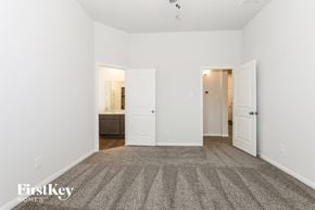 Cleveland house for rent - a bedroom with a carpeted floor and a white door to a bathroom