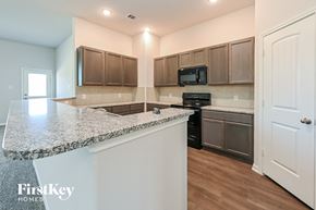 Beaumont house for rent - a kitchen with granite counter tops and stainless steel appliances
