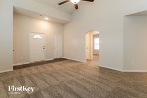 Splendora house for rent - A spacious room with a carpeted floor and a ceiling fan.