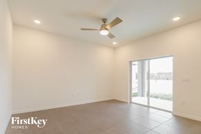 Bartow house for rent - an empty living room with a ceiling fan and a sliding glass door