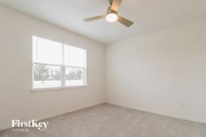 Bartow house for rent - a bedroom with a ceiling fan and a window