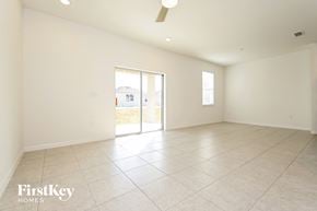 Bartow house for rent - the spacious living room has tile flooring and sliding doors to the patio