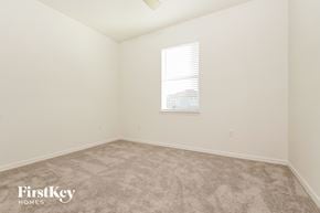 Bartow house for rent - a bedroom with white walls and carpet and a window