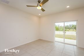 Bartow house for rent - a living room with a ceiling fan and a tiled floor