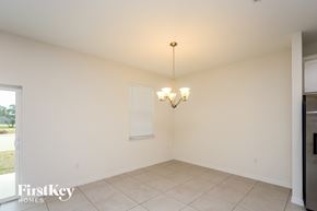 Bartow house for rent - an empty dining room with white walls and tiled floor